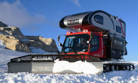 Snowcat truck camper pushing snow