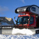 Snowcat truck camper pushing snow