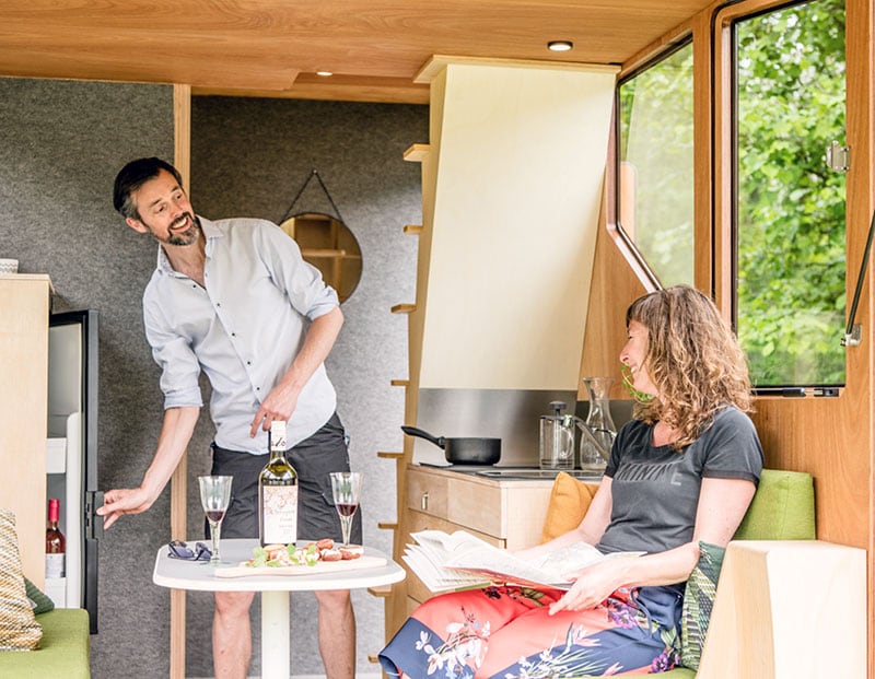 Haaks Camper Couple Enjoying Drinks In Dinette