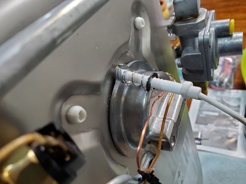 Spring And Snap Ring Holding The Igniter In Tension