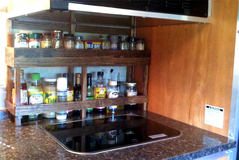 Spice Rack Behind Stove With Spices