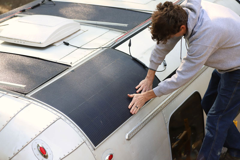 Chris Applying Pressure Along The Edges Of Each Solar Panel To Seucurly Engage The Velcro