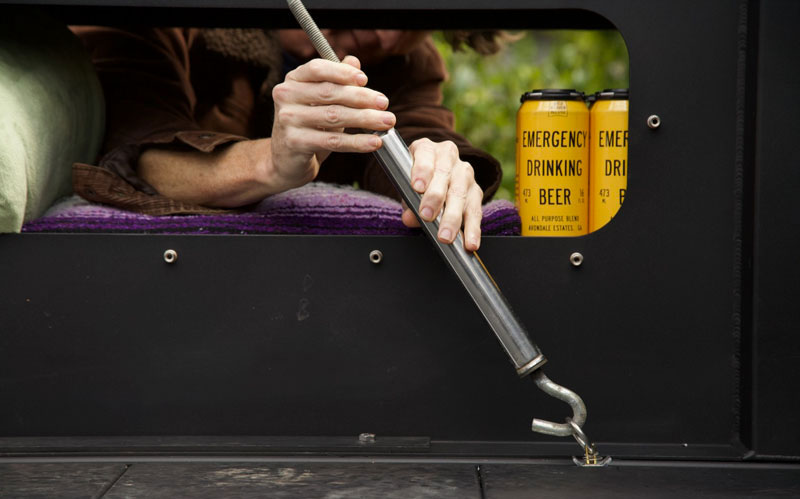 Reaching Through Interior Box Hatches To Secure A Turnbuckle To The Truck Bed