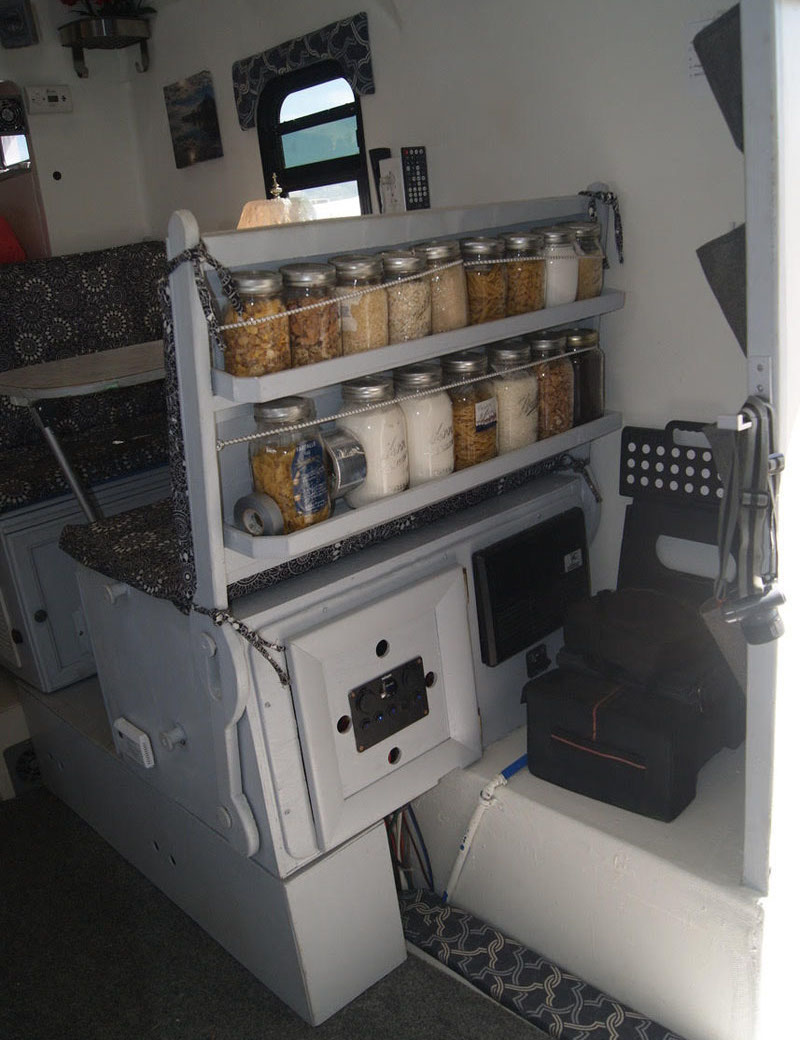 Mason jar storage on back of camper dinette