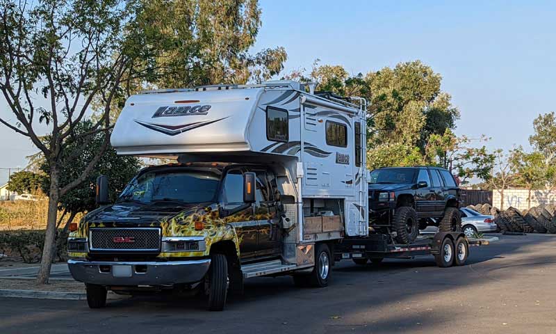 Lance And Topkick Towing In Parking Lot