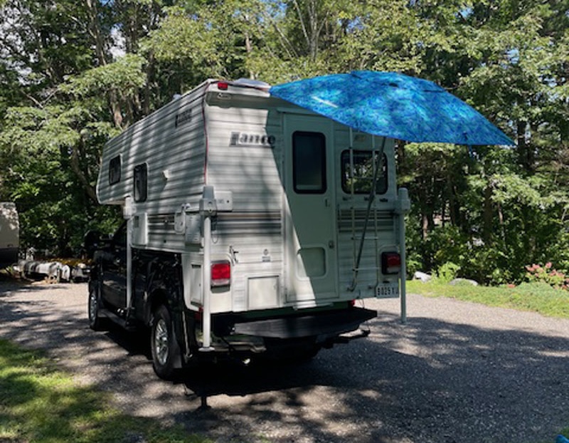 Umbrella Awning On Ladder Of Camper