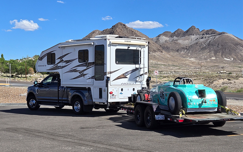 truck camper towing racecar to speedweek