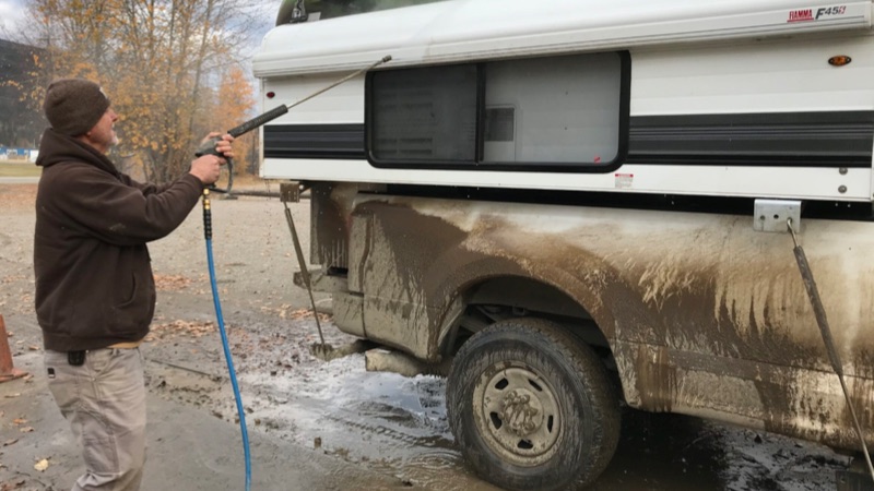 Alaskan getting washed after dirt road