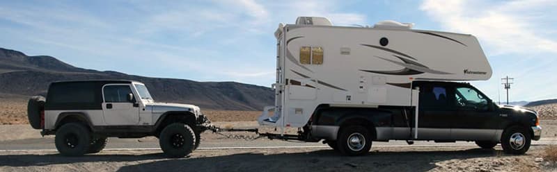 Flat towing a Jeep with a truck camper