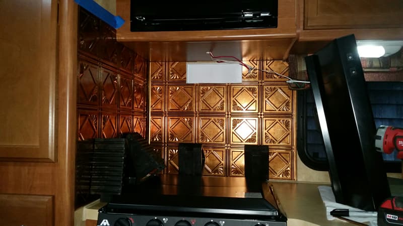 Stamped tin backsplash in truck camper