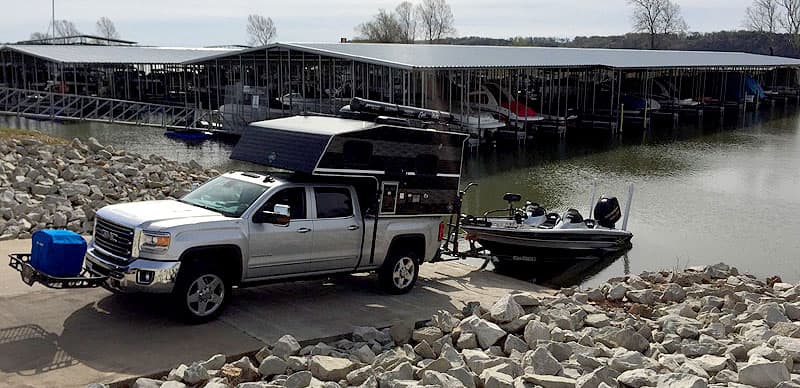 Truck camper backing down boat launch