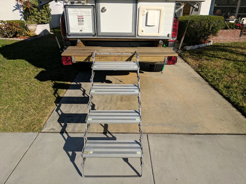 Rear camper deck and scissor steps