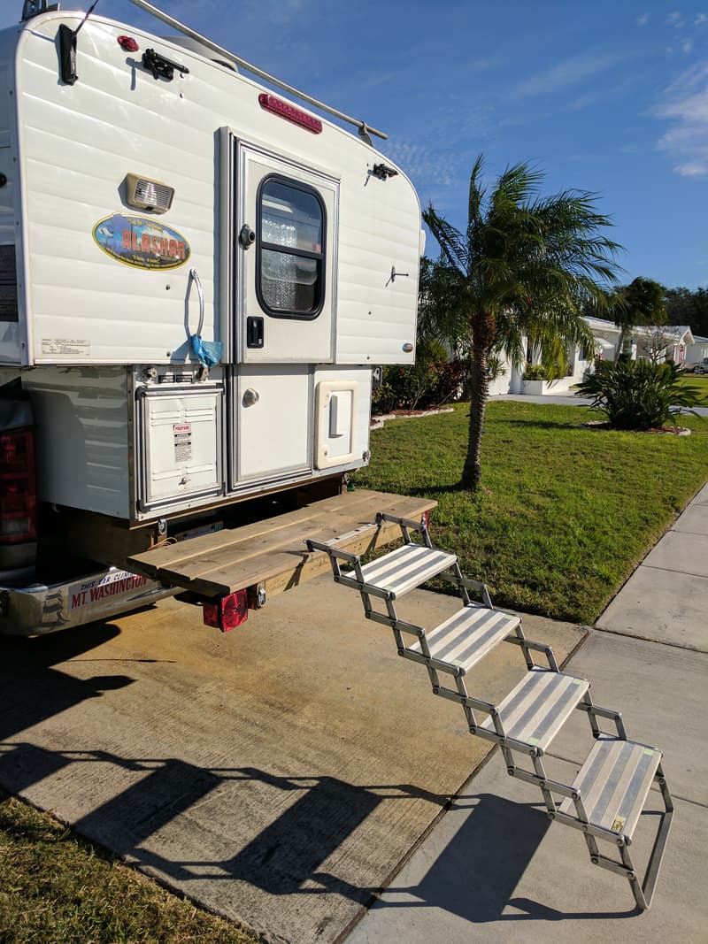 Rear camper deck and scissor steps