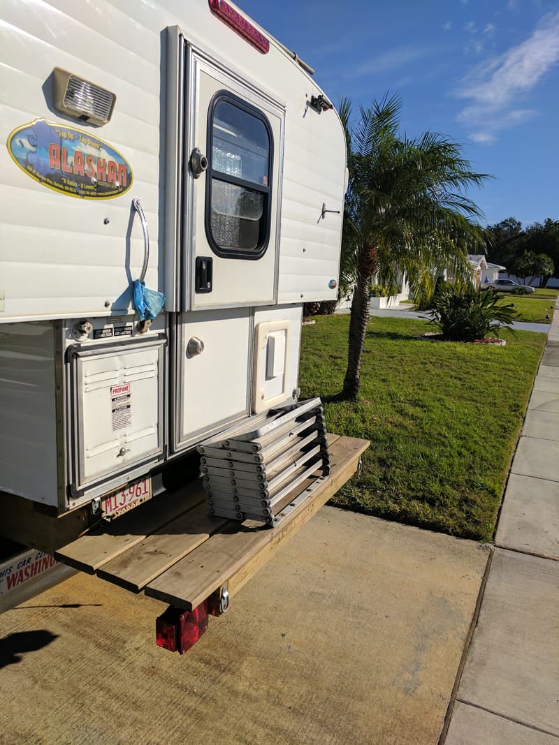 Scissor steps mounted on deck of camper