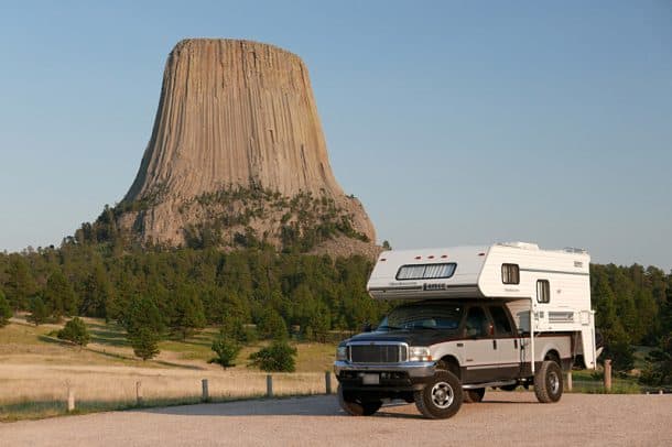 #200 - Scott and Johanna CameronDevils Tower, Wyoming2003 Ford F3502000 Lance Lite 915Camera Used - Panasonic Lumix LX100This picture is very dear to us.  On our cross-country road trip, Devils Tower had been a major climbing objective since day one.  We managed to contain our excitemen and stress for the first few months, but when we drove to the tower last August, and we saw it from the hills, miles away, it hit us.  We were about to climb to the top of that huge tower raising out of the plains of eastern Wyoming.As we arrived, we drove straight to the visitor center to inquire about the current rock climbing closures on the tower (due to falcon nesting).  The route we had planned to climb was closed, so we had to decide on a different way to achieve the summit the next day.  We drove to the overlook, took some pictures with the truck and the tower, and set up camp for the night. Neither of us slept very well and we woke up before sunrise to get an early start in hopes of avoiding afternoon thunderstorms.  We successfully made it to the top of Devils Tower, and it is definitely one of our biggest accomplishments of the trip.