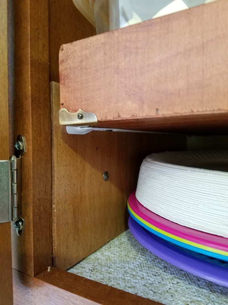 Slider bracketry on kitchen cabinet shelf