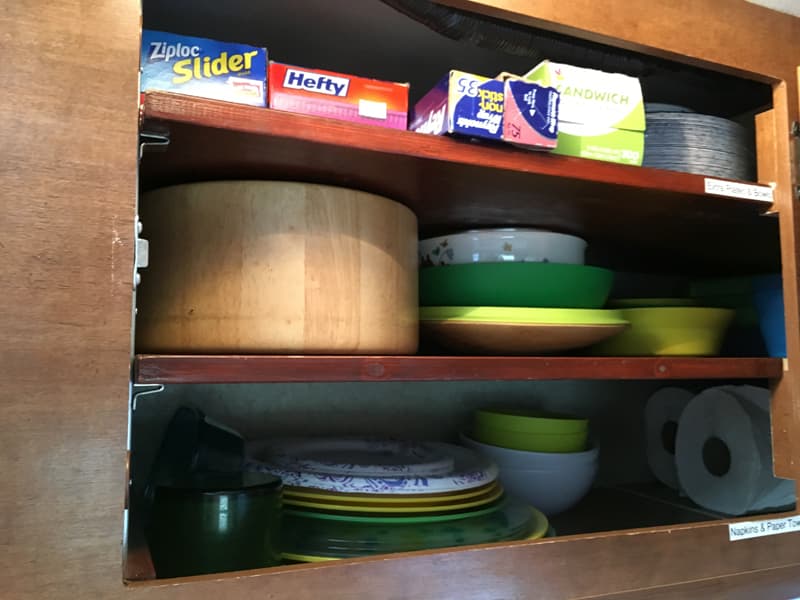 kitchen cupboards with bowls and cups