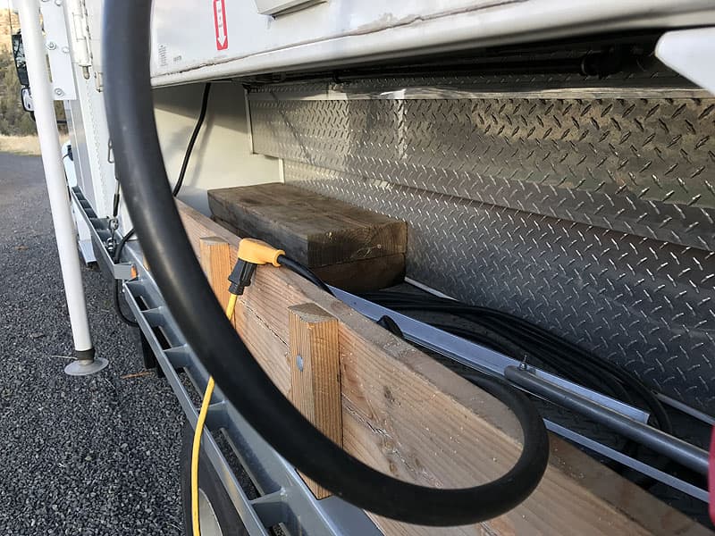 Side bin storage under camper