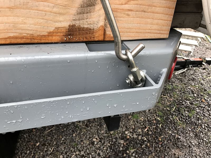 Freightliner truck camper tie-downs and turnbuckles on rub rail