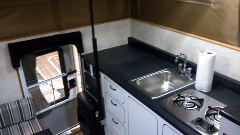 Black Staron solid surface countertops and white cabinetry