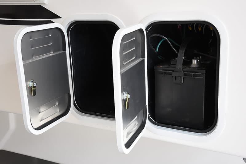 Two battery storage compartments in a Northern Lite 10-2 EX truck camper