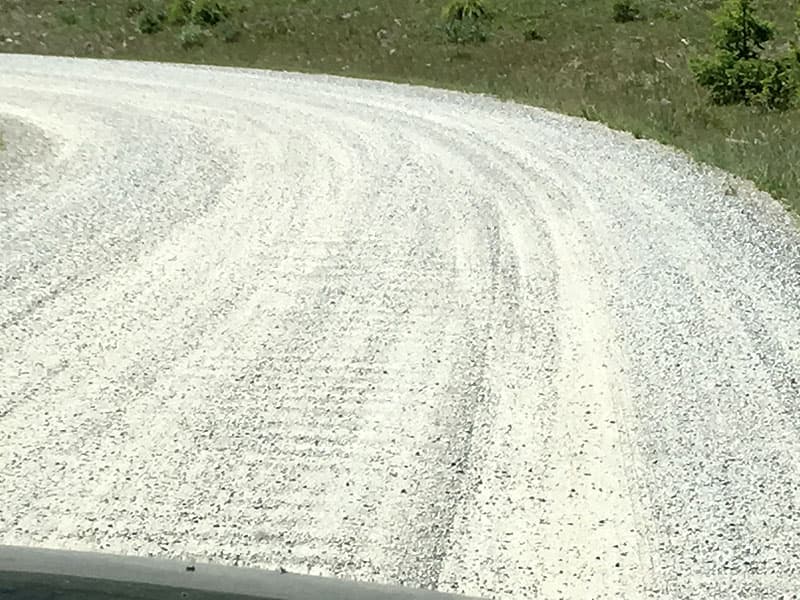 Washboard gravel road with a truck camper