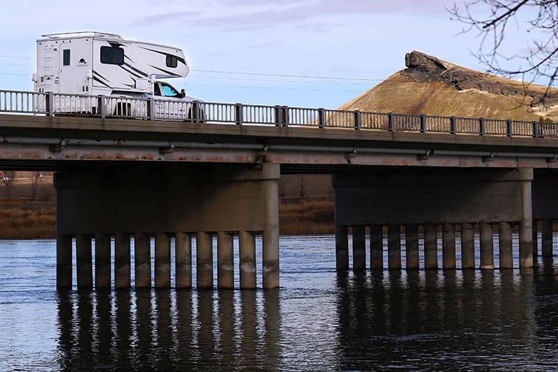 Rugged Mountain RV Camper on bridge