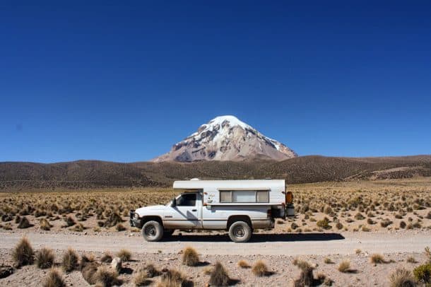 #173 - Laughlin DrakeSajama National Park, Bolivia1994 Dodge Ram1986 Alaskan Camper 10-foot caboverCamera Used - Canon EOS Digital Rebel XSAfter spending a month in Peru and the previous eight traveling there from the United States, we pulled into La Paz, Bolivia to visit a mechanic to replace our brakes that were toast after 20,000 miles of abuse.  We were told it would be a week before work would begin so we took off to Sajama National Park to continue exploring while we waited for the time to pass.Sajama National Park holds the Sajama Volcano which is the tallest peak in the high altitude country at over 20,000 feet in elevation.  We couldn't drive more than a few miles without stopping for photo shoots, most of which included our truck and camper.  Each time we stopped, our jaws dropped as we stared at this incredible mountain.  The glaciers and snow, rocks and crevices changed with each turn of the wheel and we admired its beauty with each stop.  Finally, after eight months of hot weather, our Alaskan Camper felt at home at the cold, high altitudes of Bolivia.  This was another sign that we were right where we should be.