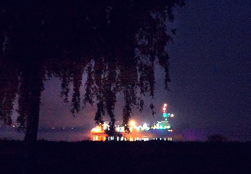 heavy ship traffic at night flowing on the Weser River