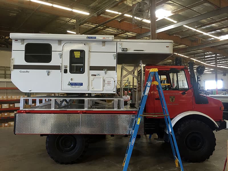 Unimog camper loaded on truck platform