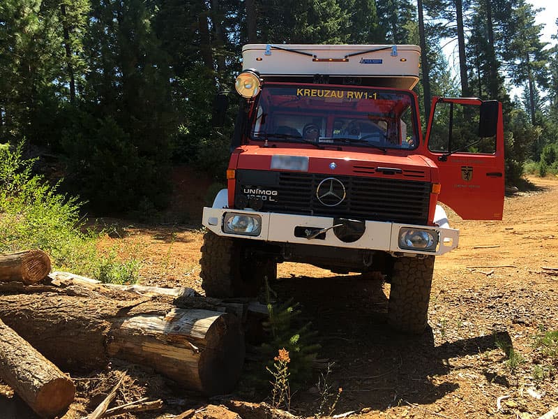 Unimog going over logs