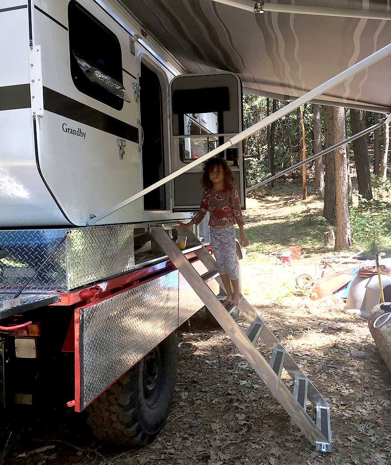 Daughter using ladder to get into Four Wheel Camper