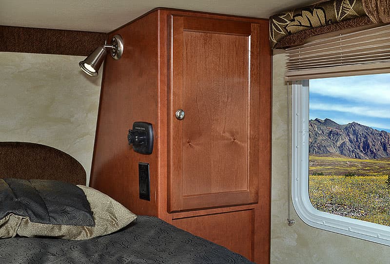 Charging station in overcab of Wolf Creek Campers