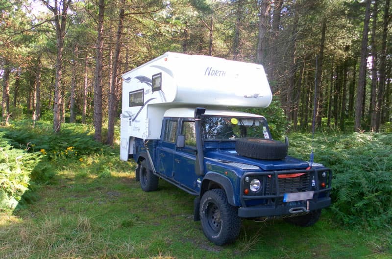 Spare tire on hood of Land Rover