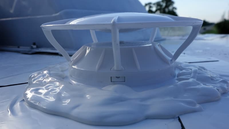 Black tank siphon vent on roof with caulk