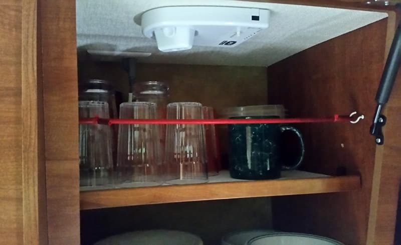 bungees to keep cups in cabinet