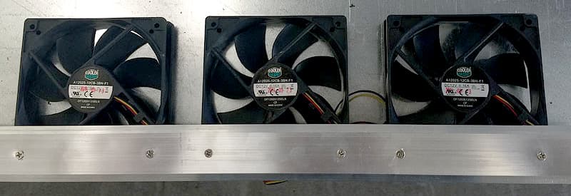 Computer fans lined up and attached to a metal bar