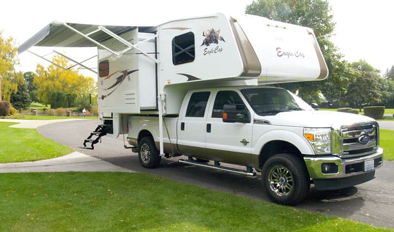 Side entry steps on a triple slide camper