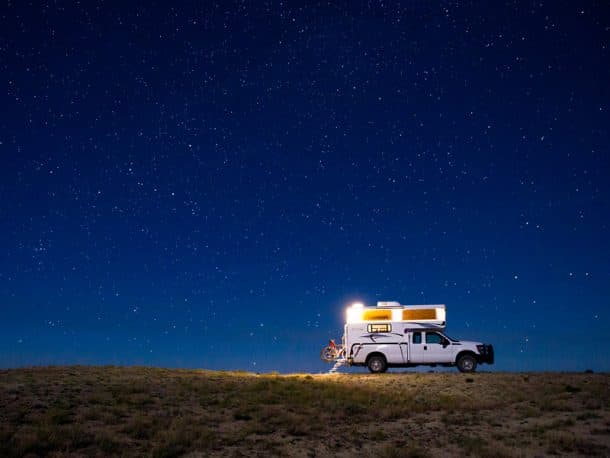 #540 - Russell GoodinRed Desert, Wyoming2012 Ford F2502012 Northstar 850SCCamera Used - Canon Rebel T2iWyoming’s Red Desert is an astonishingly beautiful place.  Many people dismiss the 108-mile stretch between Rock Springs and Rawlins as a desolate wasteland.  To be fair, it certainly seems like a wasteland from the comfort of a climate controlled passenger vehicle.  For some, the only thing worth stopping for are the emerald green lawns and 50 cent ice cream cones at the Little America Travel Center.  On the first leg of a solo 10-day road trip, I was attempting to drive non-stop from my house in Oklahoma City to my parents’ home in Ogden, Utah.  I really had no reason to attempt such a long drive.  It seems silly now.With the truck fueled and packed earlier in the week, I left OKC before 4 AM on Friday, June 30th as mid-summer thunderstorms passed overhead.  I headed north on I-35 to Salina, Kansas, west on I-70 to Denver, then north on I-25 before exiting to US 287 for a scenic shortcut to Laramie, Wyoming.  On schedule to arrive in Ogden at 10 PM, I had time to take a few sunset photos.  As the sun approached the western horizon, I exited I-80 at Tipton North Road (exit 158), a well-maintained gravel road that appears to service oil and gas facilities in the Wamsutter Field.Traveling north past a gas processing plant, I was struck by the number of Pronghorn Antelope in the area.  A little further up the road, I passed a small herd of elk.  Apparently, the Red Desert is home to the largest population of desert-dwelling elk in the world.  Recognizing that I didn’t have much sunlight left, I decided to follow an unmaintained dirt road to the crest of a small ridge where I thought I could find a good photo location.  A faint clearing in the sparse vegetation indicated an old camp site.  The ridge provided an overlook to a high-elevation desert basin; one that does not drain to any of the world’s oceans.  Here, the continental divide splits and wraps around both sides of what has been named the Great Divide Basin.From my overlook, I could see north past the Oregon Buttes and Killpecker Sand Dunes.  In fact, the jagged peaks of the Wind River Range, over 75 miles away, were visible just above the horizon.  While taking photos, the crisp desert air, huge skies, and complete solitude created and overwhelming sense of home.  I could not bring myself to leave.  I let my parents know I’d be delayed and popped the top on the Northstar (and a Founder’s All Day IPA).Other than the occasional chorus of howling coyotes and curious antelope, the night was completely still.  Taking photos well into the night, I woke up at sunrise and reluctantly continued my journey to Ogden, Moab, the Abajo Mountains, and Hovenweep National Monument.  I’m not sure why, but the Red Desert was the highlight of my trip.  It is a place that stays with me.  I can’t wait to go back and really explore.