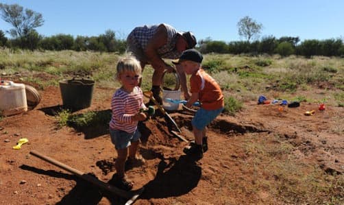 Kids digging in the dirt for gemstones