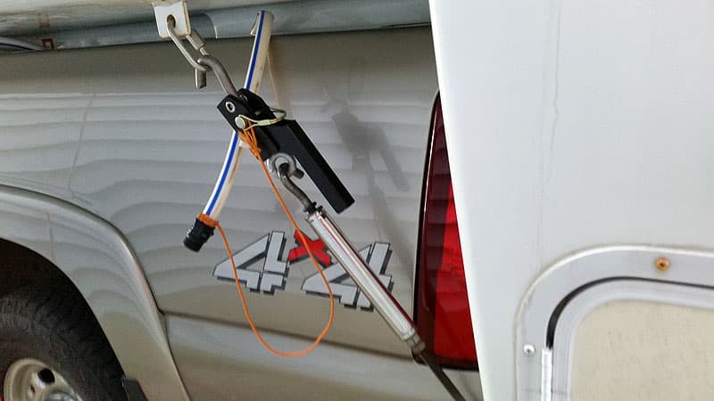 Water hose storage in truck bed