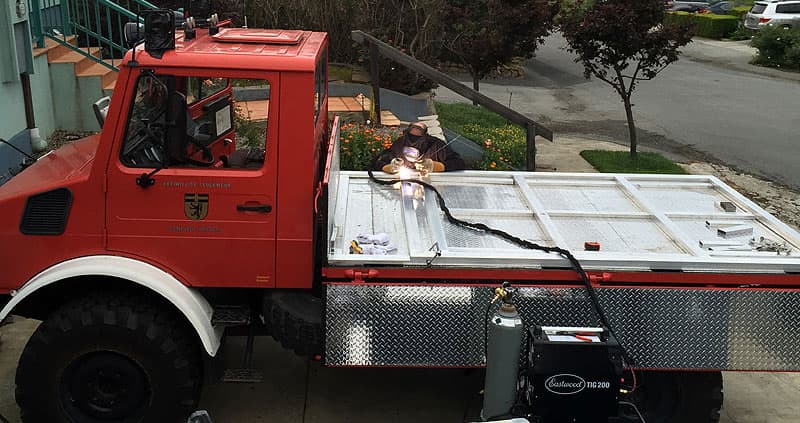 Daniel welding the platform for the Unimog flatbed truck